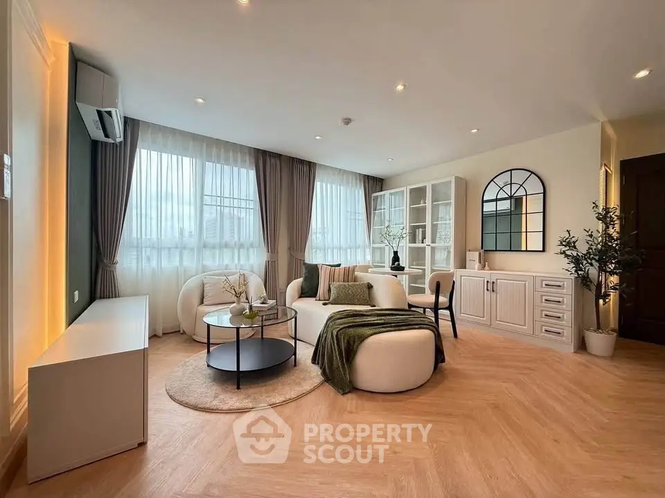 Spacious modern living room with elegant decor and large windows