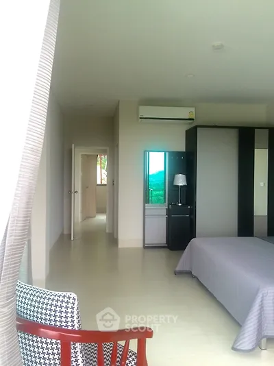 Spacious bedroom with modern amenities, large bed, and a serene view, featuring an en-suite bathroom and ample natural light.