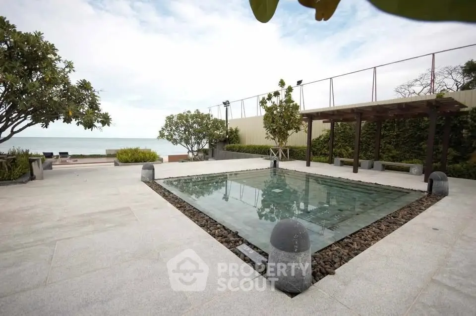 Luxurious outdoor pool area with ocean view and modern landscaping.