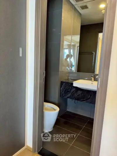 Modern bathroom with sleek design and elegant fixtures in a contemporary apartment.