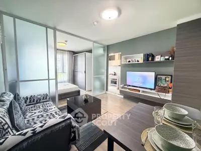 Modern living room with stylish decor and open kitchen layout in a cozy apartment.