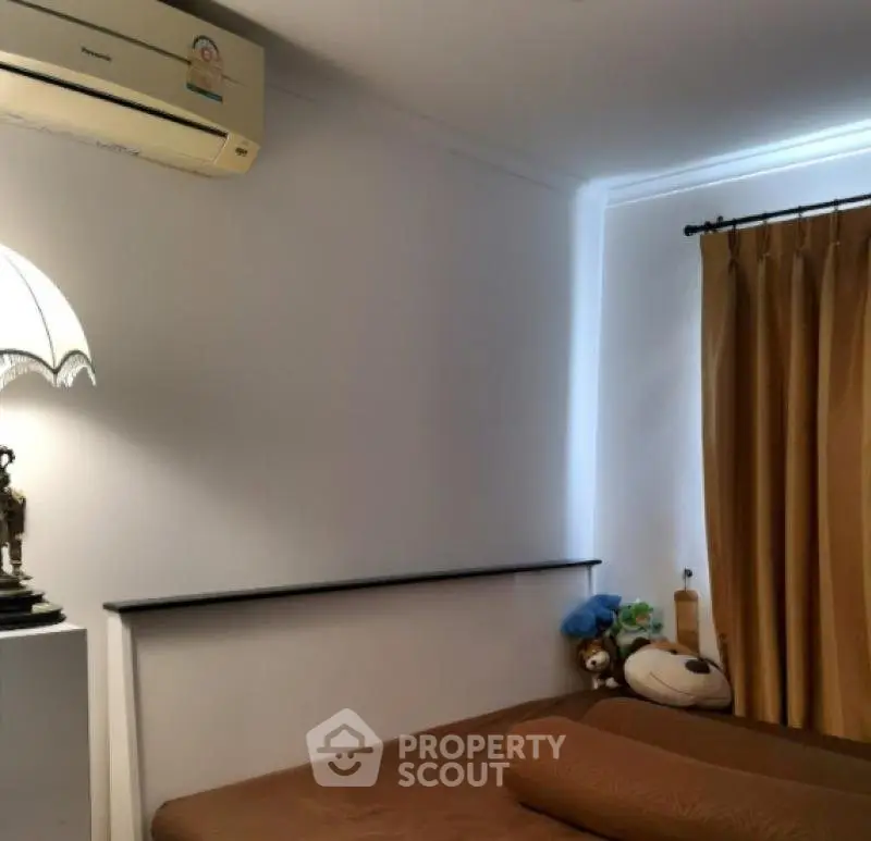 Cozy bedroom with air conditioning and warm lighting, perfect for relaxation.