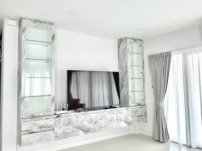 Modern living room with marble TV unit and elegant curtains
