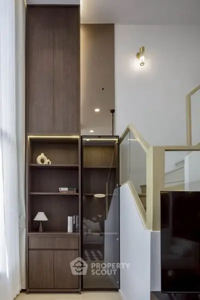 Modern interior with stylish wooden shelving and elegant staircase design