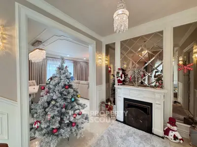 Elegant living room with festive Christmas decor and chandelier lighting
