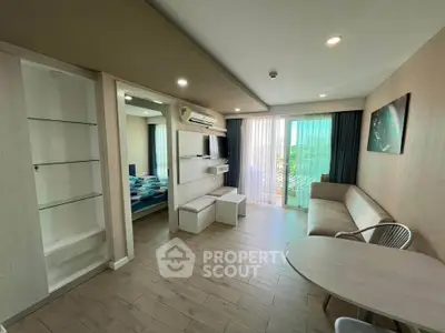 Modern living room with sleek furniture and large windows offering natural light.