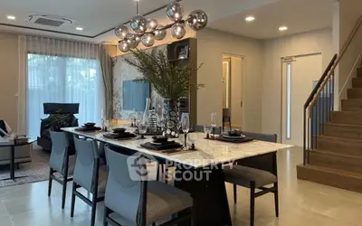 Elegant dining area with modern chandelier and stylish decor in a contemporary home.