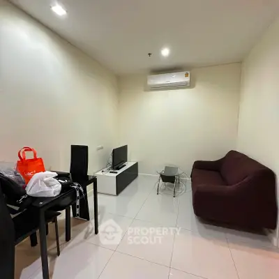 Cozy living room with modern furniture and air conditioning in a compact apartment.