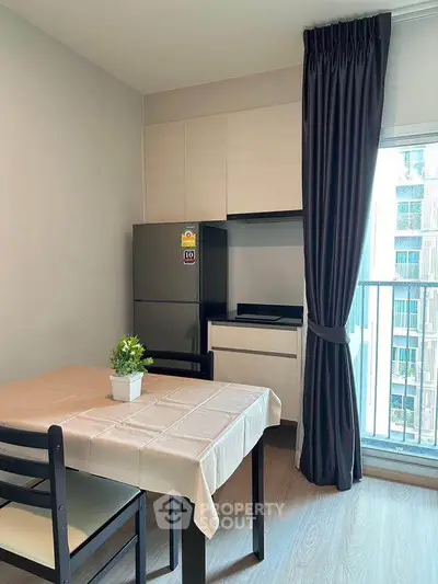 Modern kitchen with dining table and balcony view in a stylish apartment