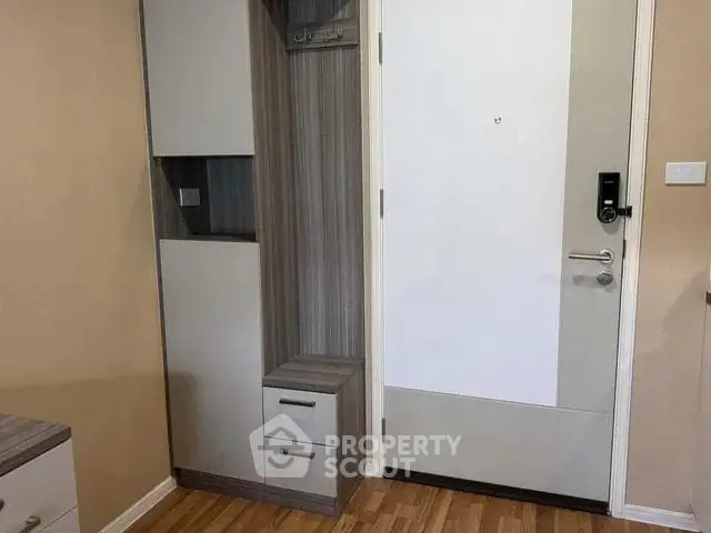Modern apartment entrance with sleek storage and digital lock