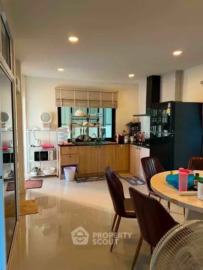 Modern kitchen with sleek cabinets and dining area in a cozy apartment
