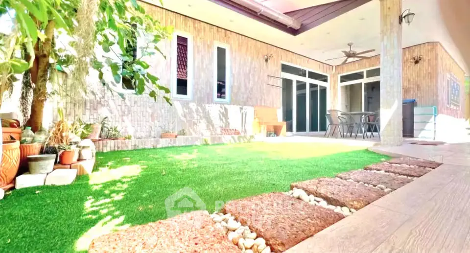 Charming garden patio with lush greenery and modern outdoor seating area