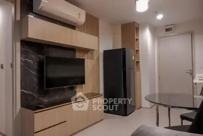 Modern living room with sleek furniture and wall-mounted TV in stylish apartment.