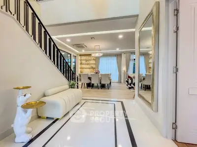 Luxurious open-plan living and dining area with elegant decor and modern furnishings.