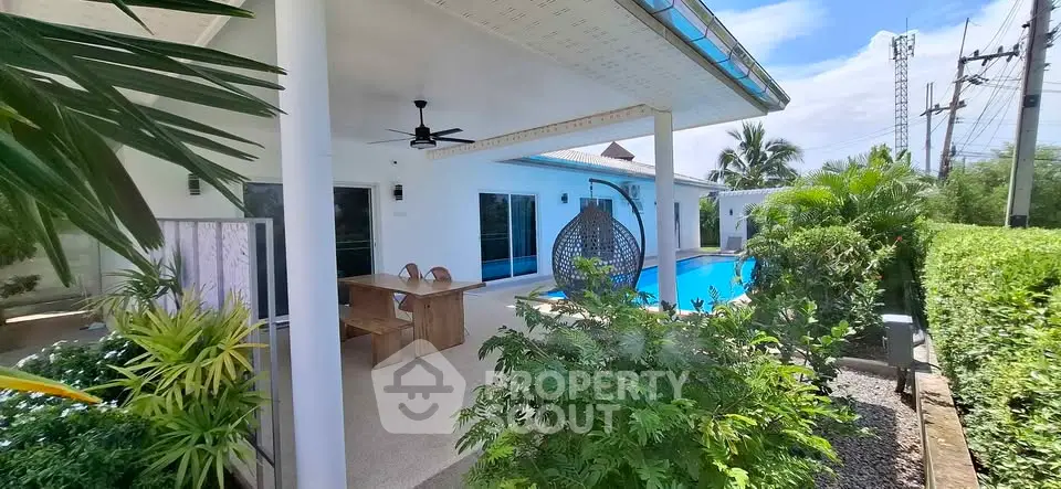 Luxurious villa with private pool and lush garden, perfect for tropical living.