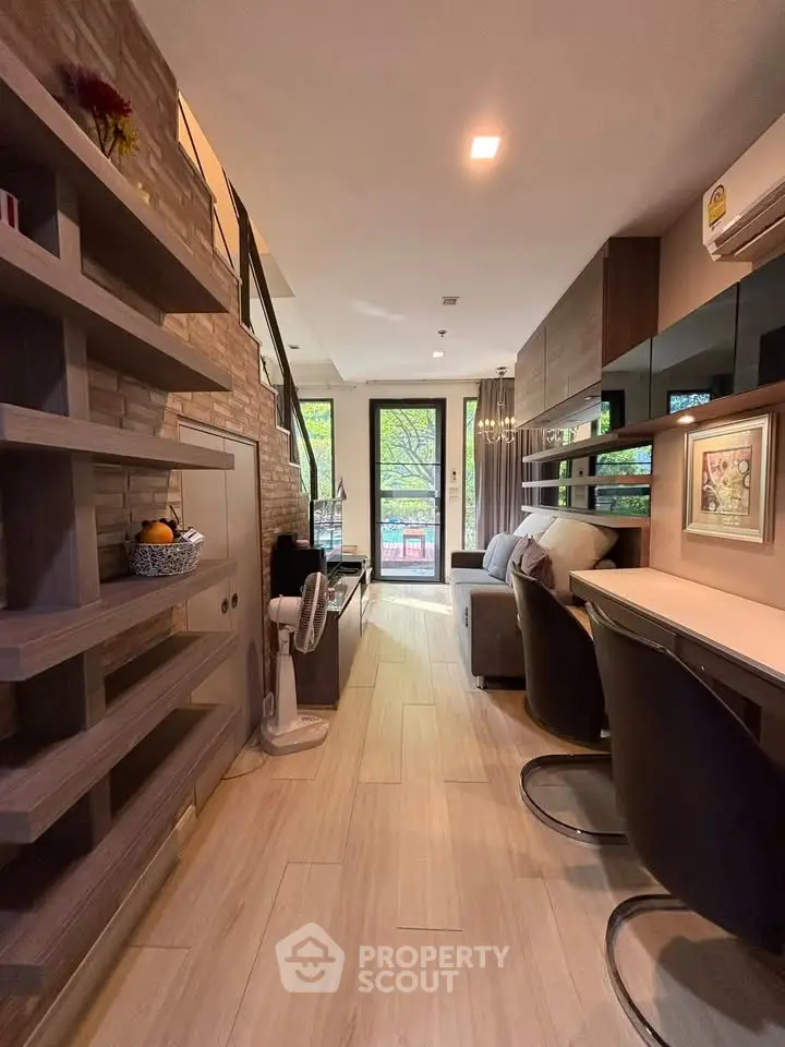 Modern living room with stylish decor and open layout, featuring large windows and elegant furnishings.
