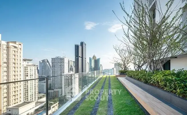 Stunning rooftop garden with panoramic city views and modern glass railing.