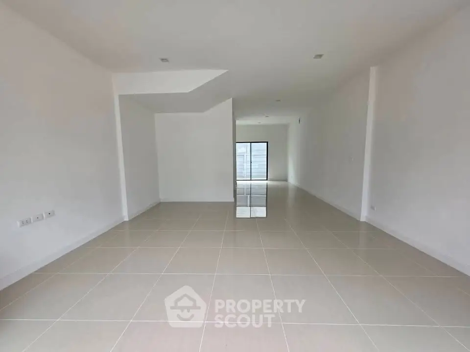 Spacious open-plan interior with tiled flooring and modern design