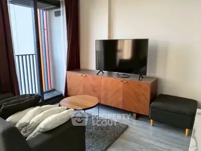 Modern living room with sleek TV setup and balcony access