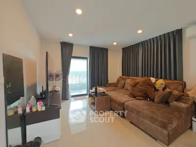 Spacious living room with large sofa and modern decor