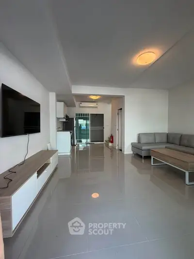 Modern living room with sleek furniture and open kitchen layout