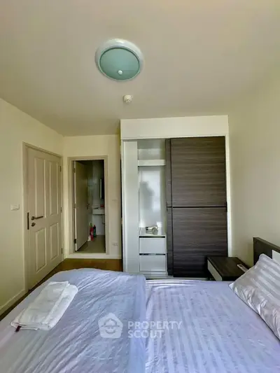 Cozy bedroom with modern wardrobe and soft lighting