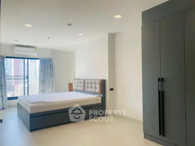 Spacious modern bedroom with city view and large wardrobe