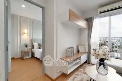 Modern apartment interior with cozy living room and stylish bedroom, featuring large windows and elegant decor.
