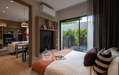 Modern bedroom with stylish decor and private balcony access, featuring cozy bedding and natural light.