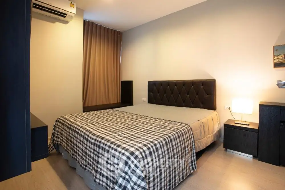 Cozy bedroom with modern decor and ample natural light, featuring a comfortable bed and stylish furnishings.
