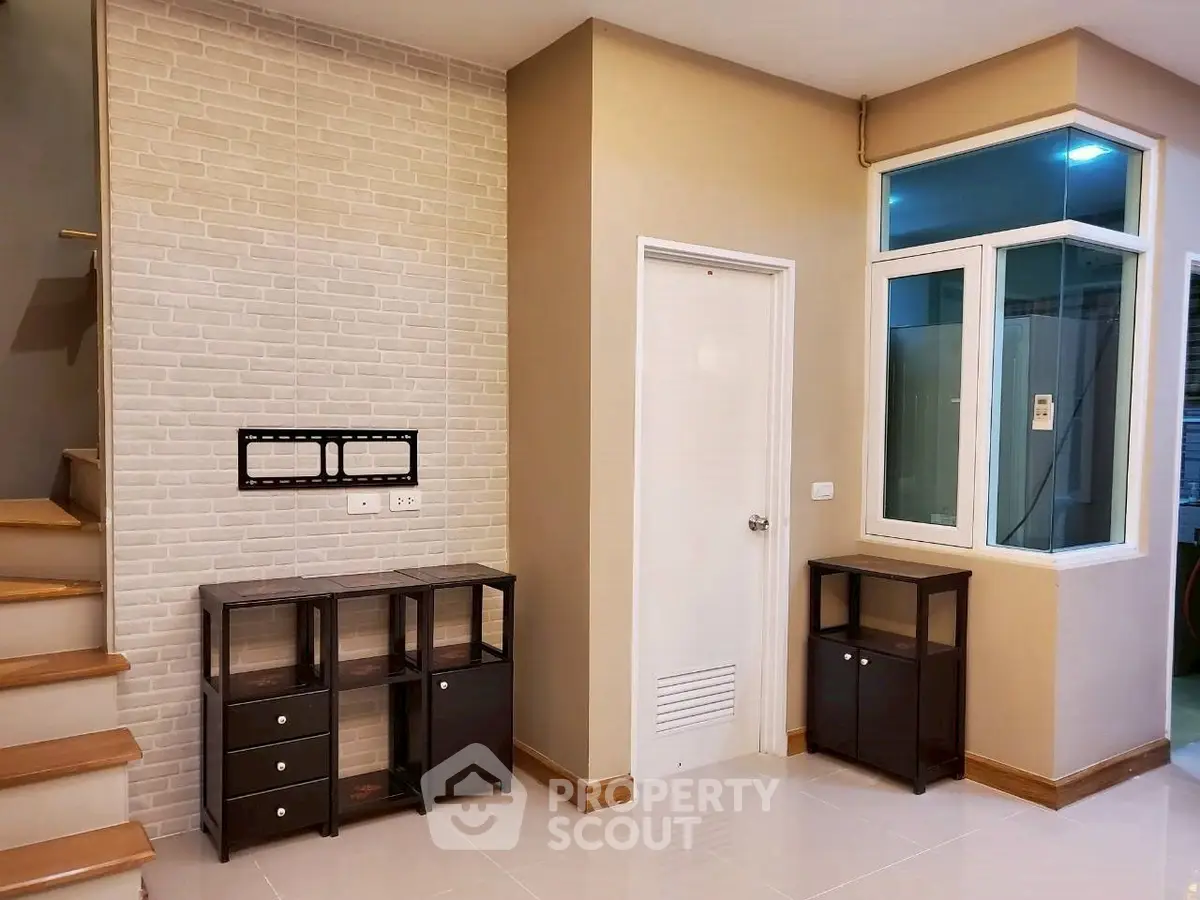 Modern interior with stylish staircase and storage units, perfect for contemporary living.