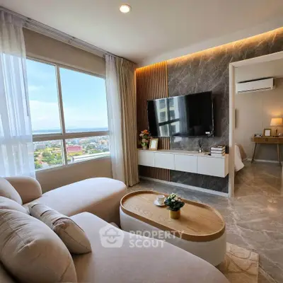 Modern living room with large window and stylish decor, featuring a comfortable sofa and wall-mounted TV.