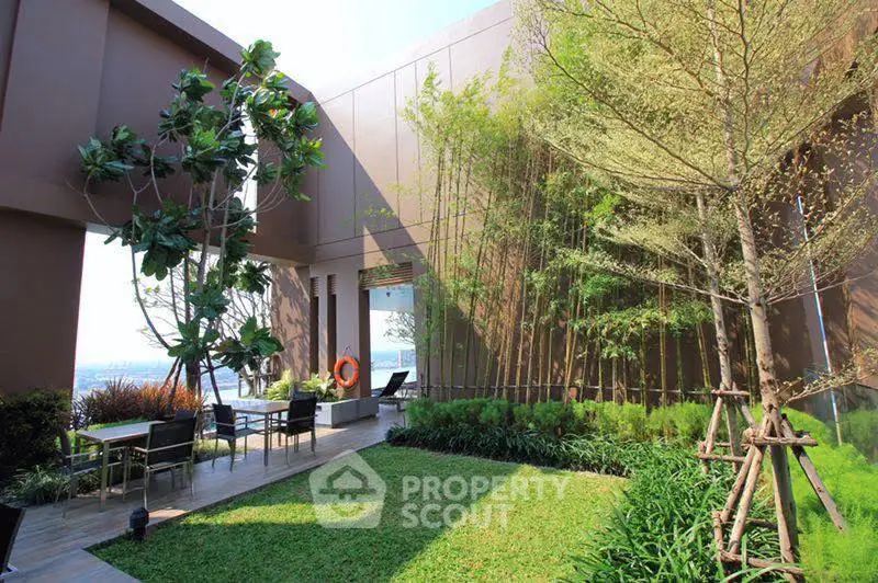 Luxurious rooftop garden with lush greenery and seating area offering stunning views.