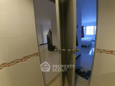 Spacious bedroom with modern decor and tiled entrance