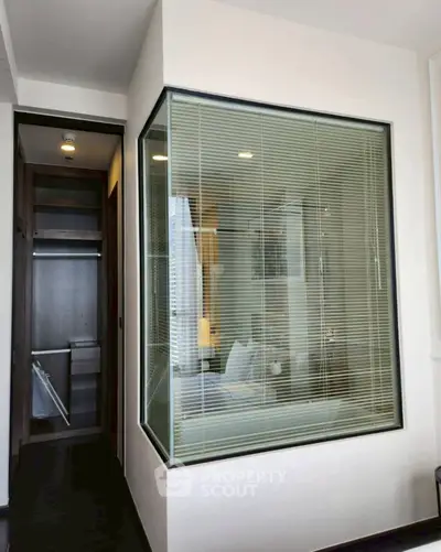Modern bathroom with glass partition and walk-in closet