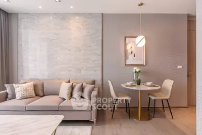 Modern living room with elegant decor and cozy dining area, featuring a stylish sofa and chic lighting.