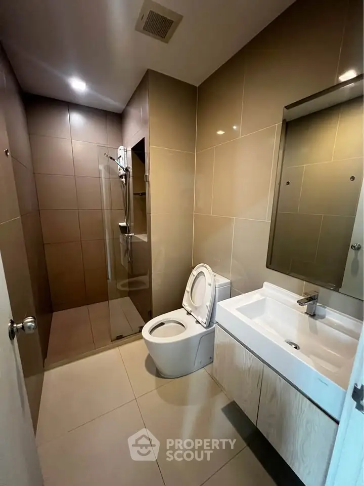 Modern bathroom with sleek fixtures and spacious shower area