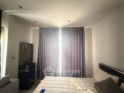 Cozy bedroom with soft lighting and elegant curtains, perfect for relaxation.