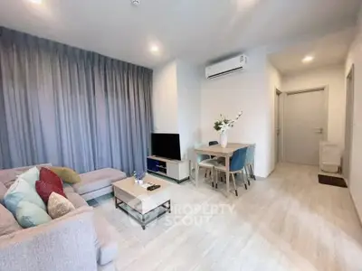 Modern living room with cozy sofa and dining area in stylish apartment