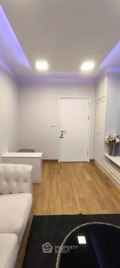 Modern living room with wooden flooring and ambient lighting