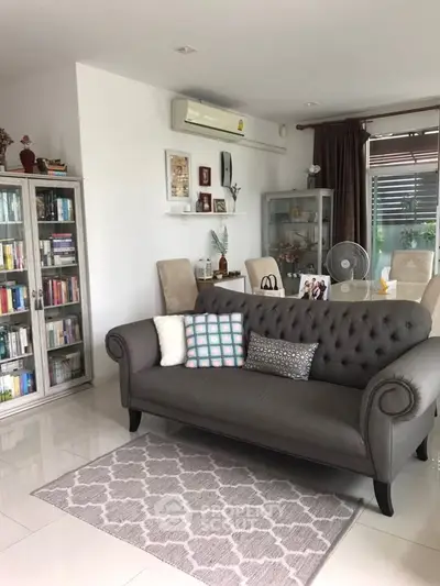 Charming living room with elegant sofa and stylish decor, perfect for relaxation and entertaining.