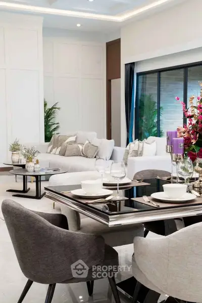 Luxurious modern living room with elegant dining area and plush seating.