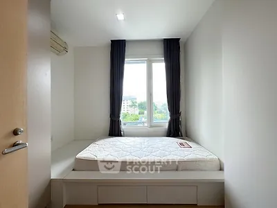 Cozy bedroom with large window and natural light in modern apartment