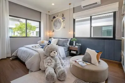 Charming bedroom with cozy decor and large teddy bear, perfect for relaxation.