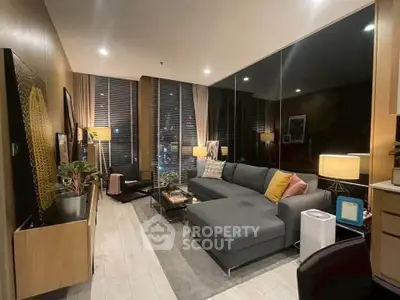 Modern living room with stylish decor and large windows in a cozy apartment.