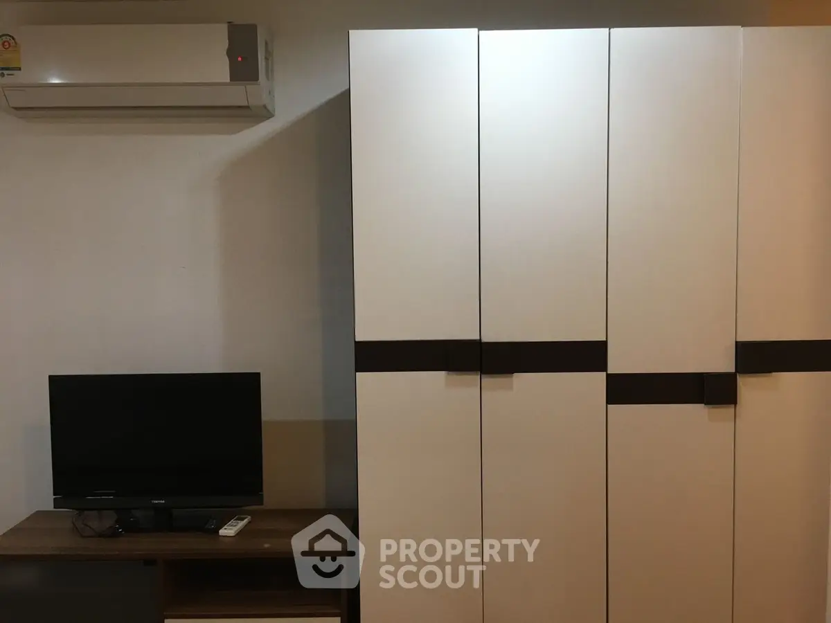 Modern interior with air conditioning and sleek wardrobe in a cozy living space.