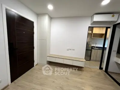 Modern apartment interior with wooden flooring and sleek kitchen design