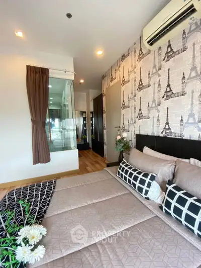 Chic bedroom with Paris-themed wallpaper and modern decor in a stylish apartment.