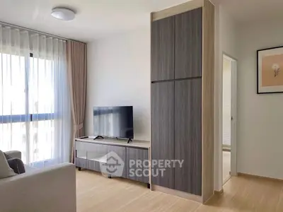 Modern living room with sleek TV stand and large window for natural light