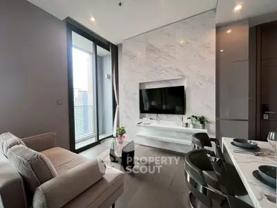 Modern living room with marble wall, sleek furniture, and city view balcony.